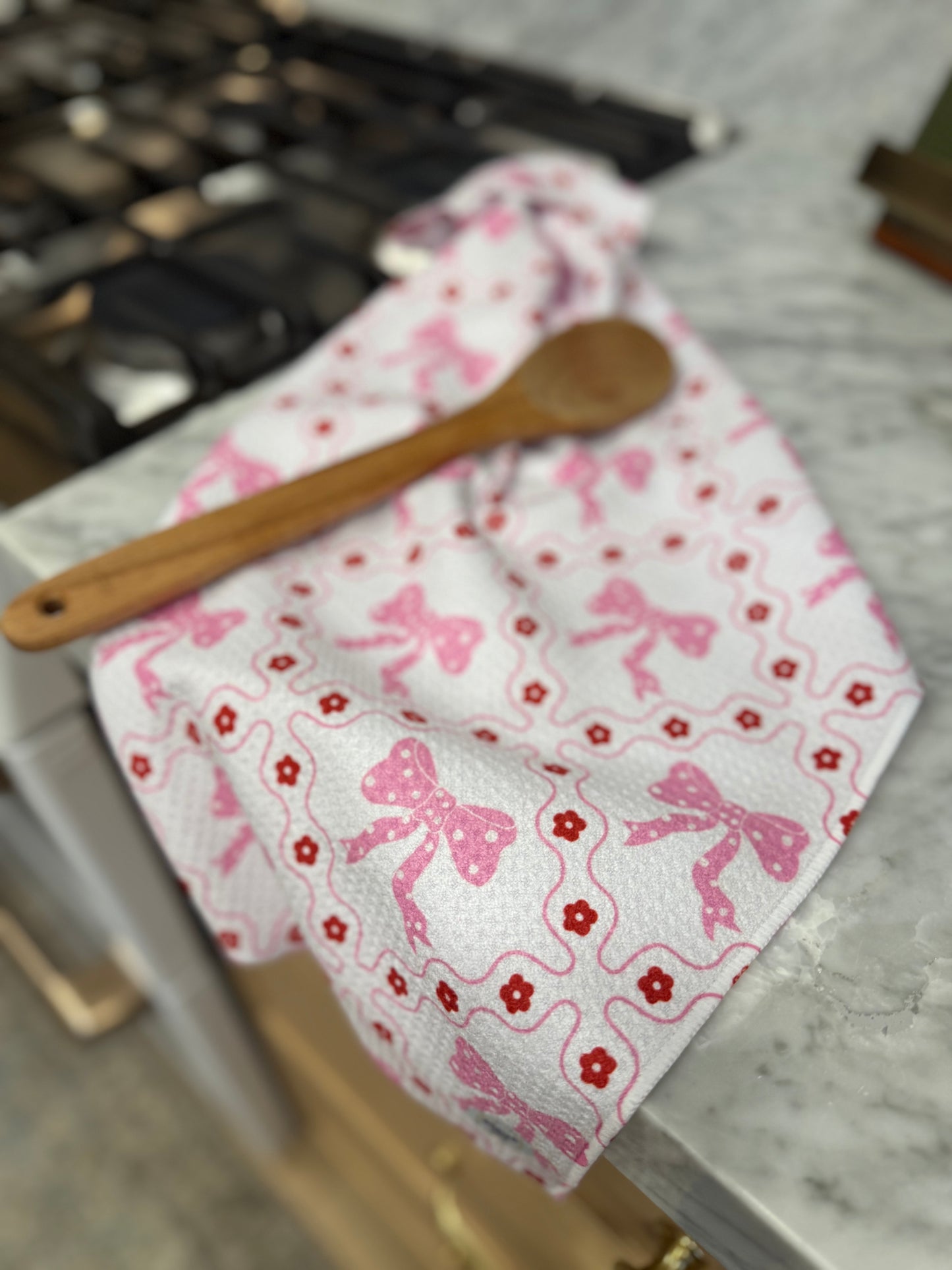 valentines dishtowel with wooden spoon resting on it