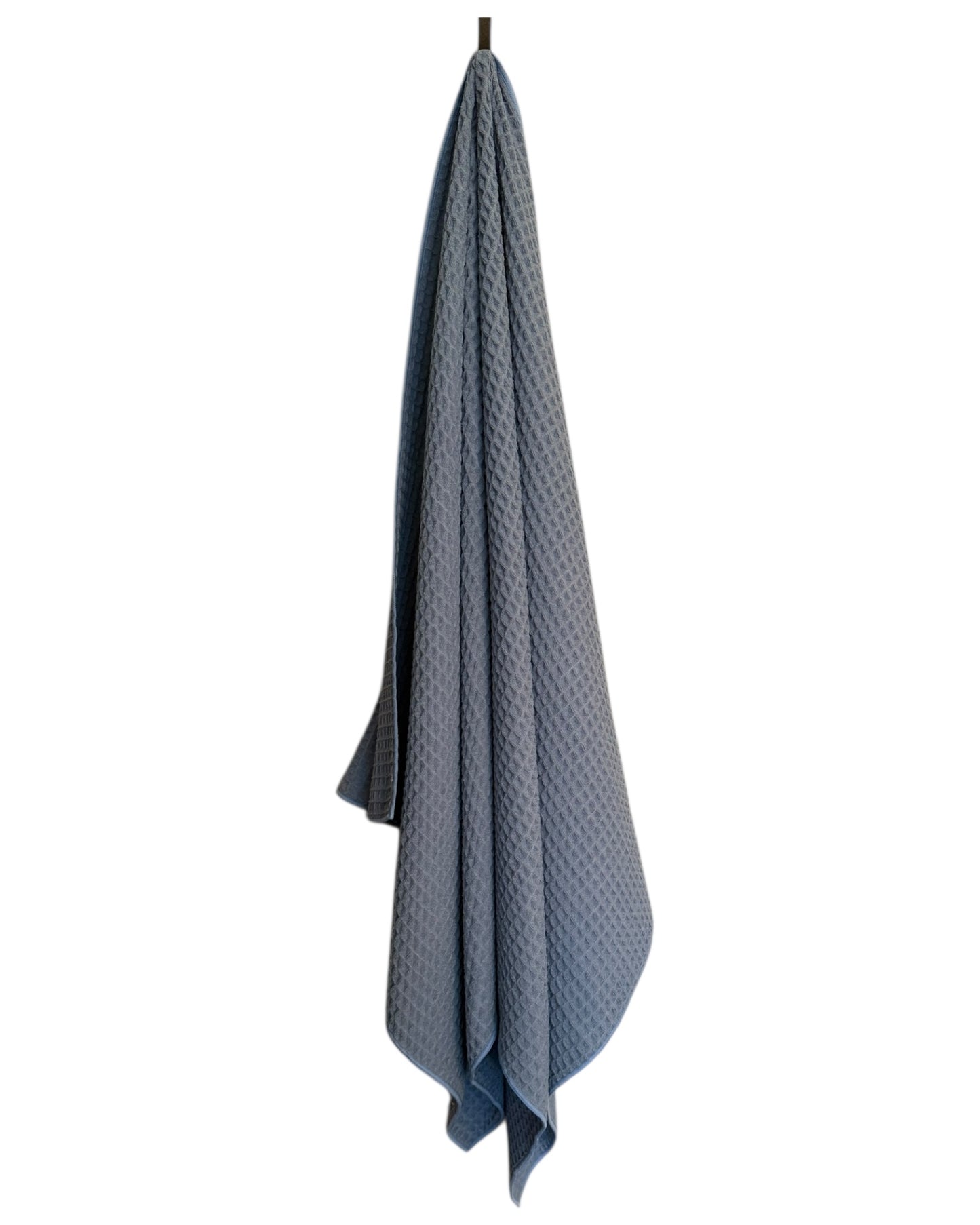 light blue textured towel hanging on a hook against a white background