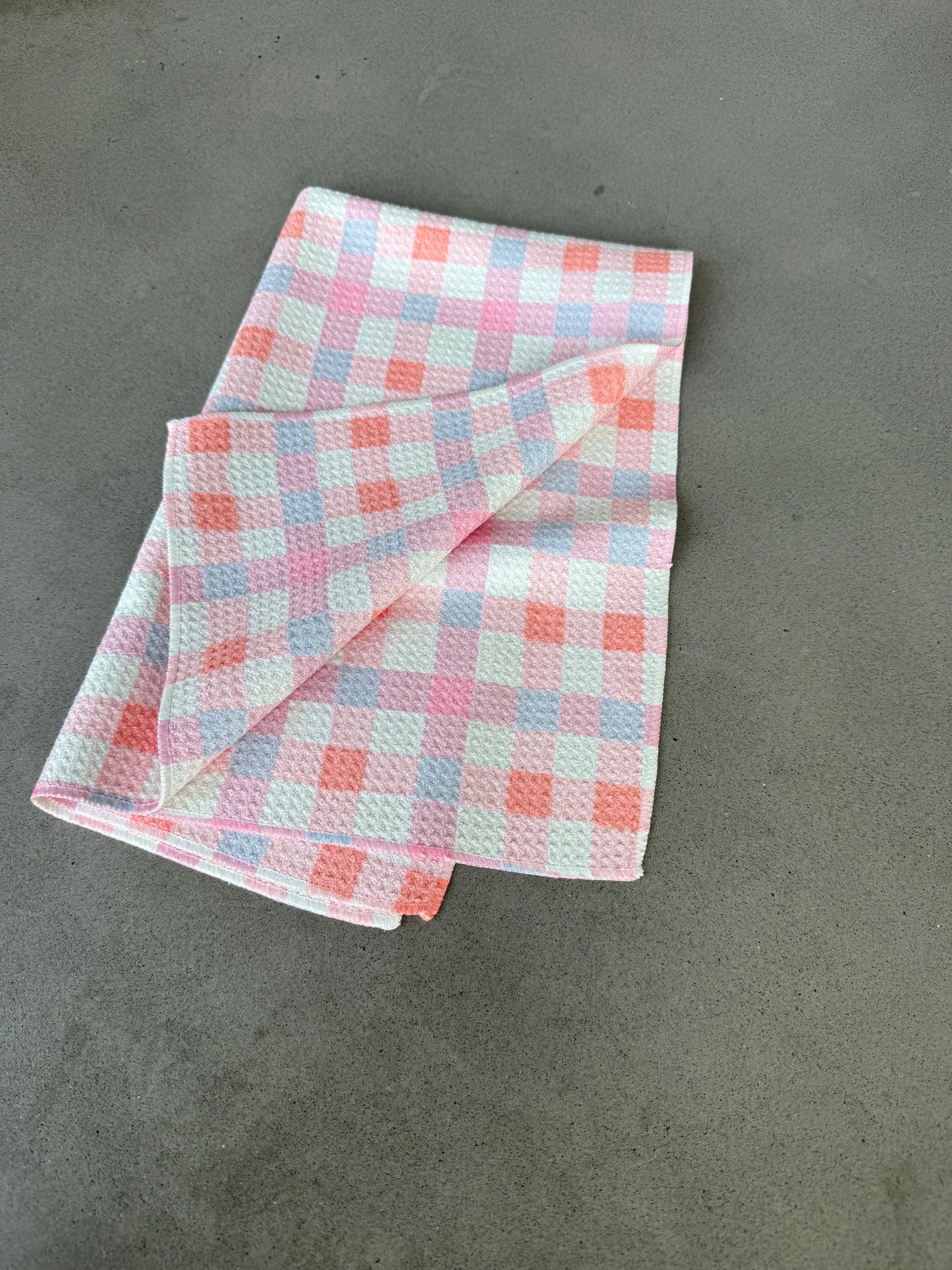 Folded checkered fabric on a gray surface