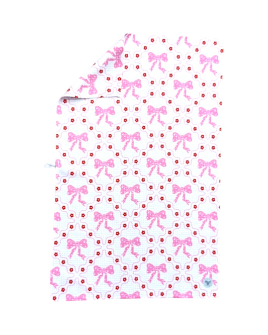 dish towel with pink bow and dot pattern on a white background
