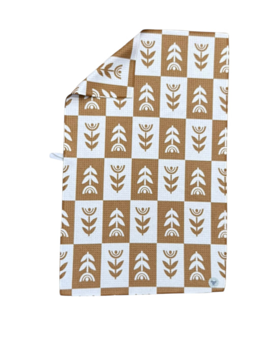 Patterned TOWEL with brown and white geometric design on a white background